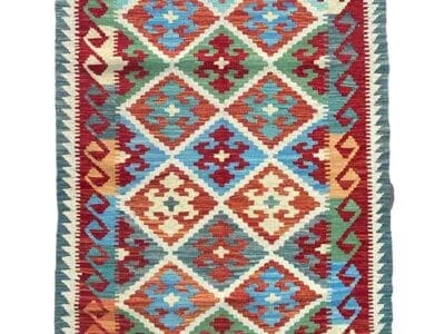 Galleria Tabriz - Tappeti in vendita. Un tappeto Bozza automatica con motivi geometrici colorati, forme a diamante e bordo sfrangiato.