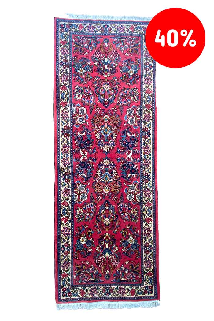 Galleria Tabriz - Tappeti in vendita. Tappeto rosso con fantasia floreale e frange bianche. Un'etichetta circolare rossa con sconto nell'angolo recita 