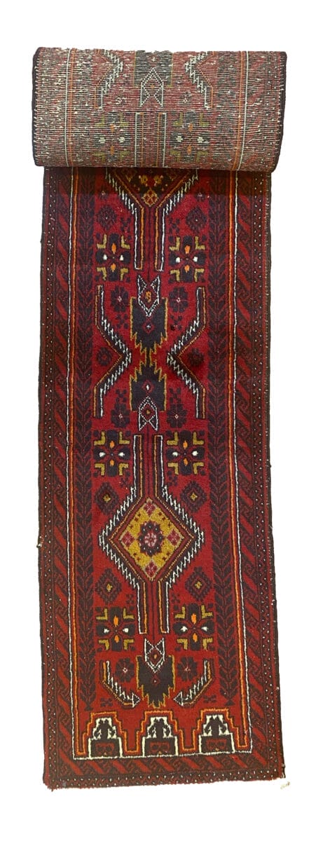 Un tappeto runner afgano con un disegno rosso e giallo.